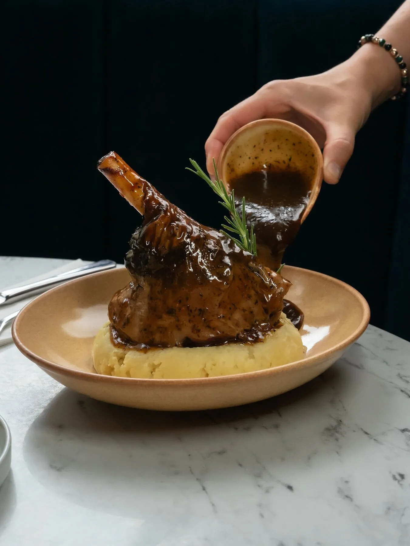 Gravy poured over lamb shank